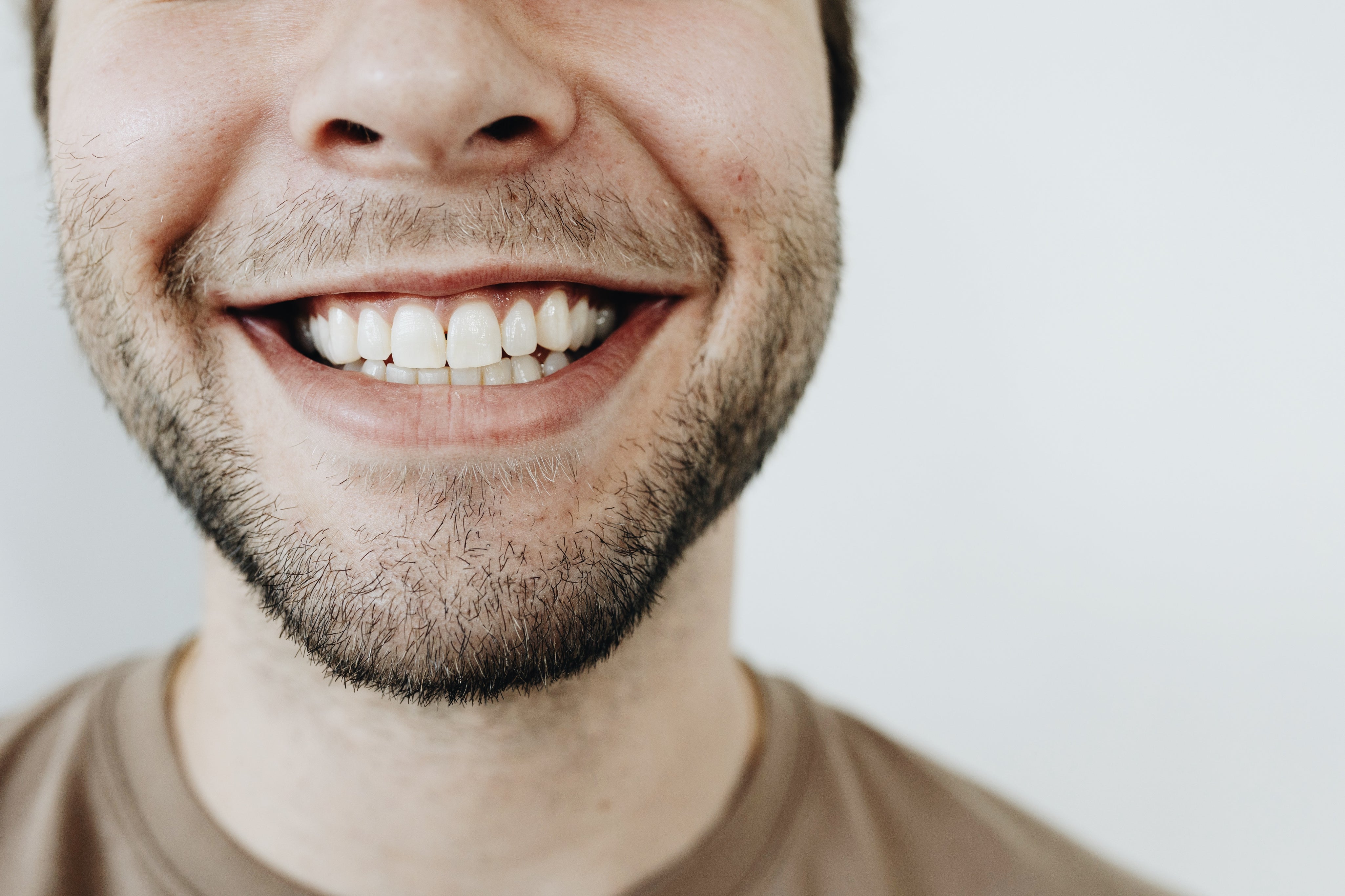 Close-up of a smiling man’s mouth, symbolizing Tannin&#39;s compassionate approach to creating products that enhance oral health and well-being.